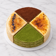 Load image into Gallery viewer, Millie crepe cake in four flavour quarters, tiramisu, brulee, matcha and earl grey, on white marble