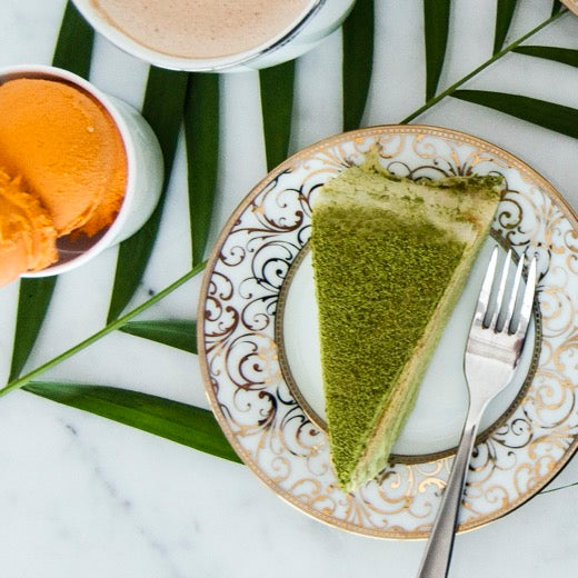 Matcha crepe cake slice dusted with green tea