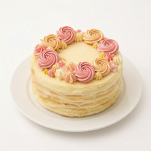 Load image into Gallery viewer, Delicate crepe cake with pink frosting on a white background

