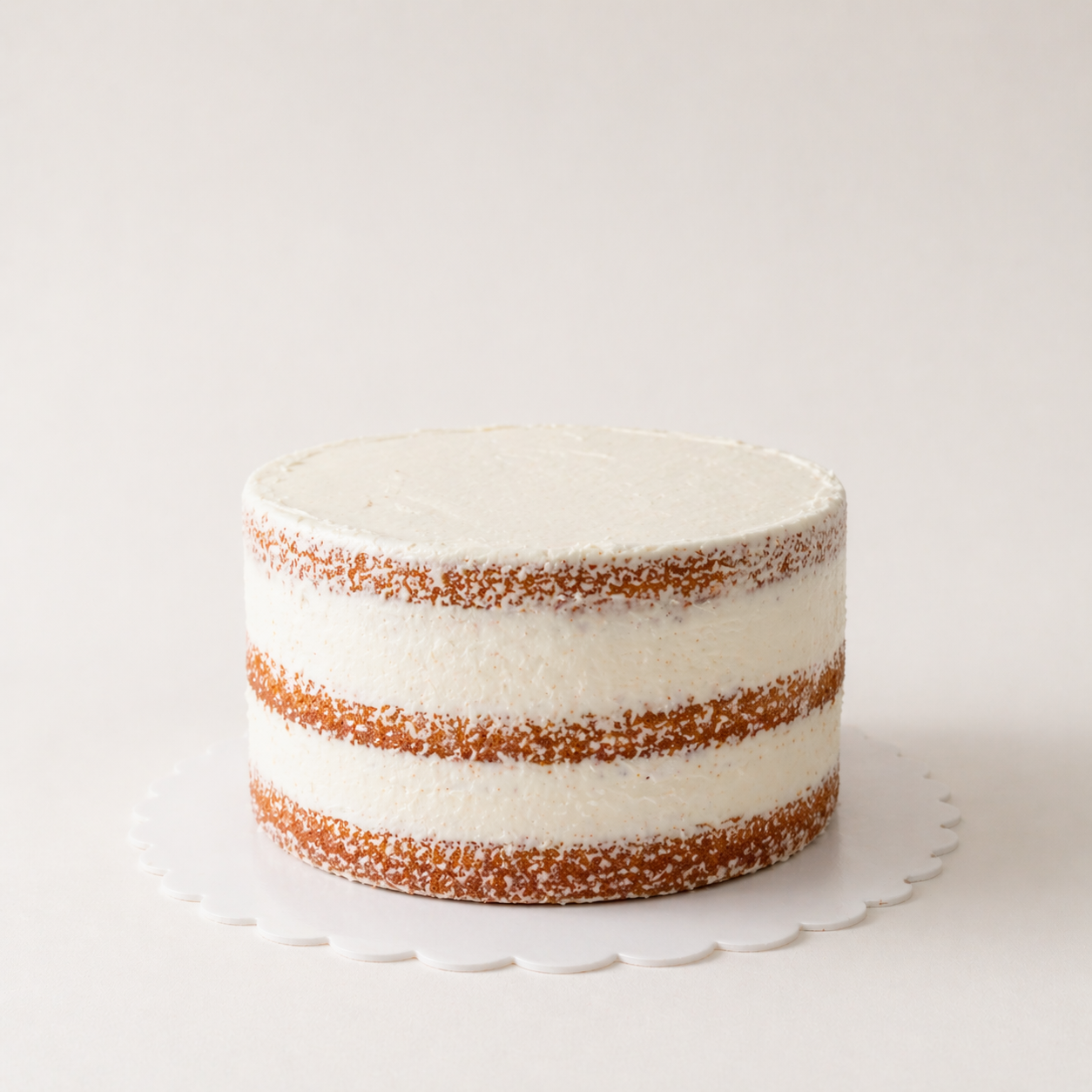 Naked cake with exposed sponge layers and cream